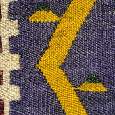 Close-up of a colorful handwoven Turkish kilim showcasing intricate geometric designs and traditional motifs.